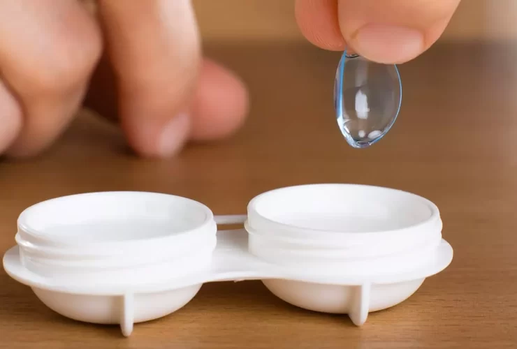 contact lenses being removed from case