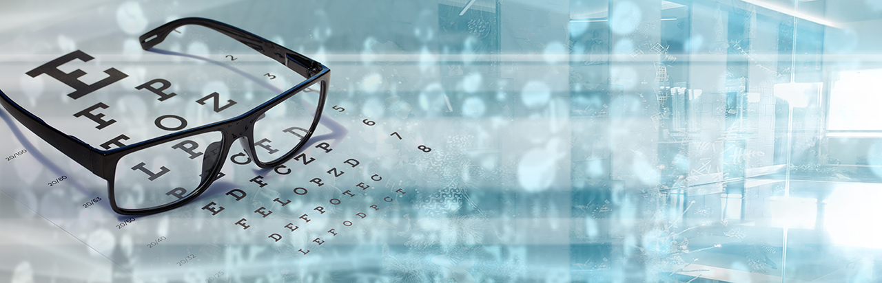 picture of glasses on eye chart and technology to correct refractive errors