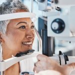 Female patient with vision insurance getting an eye exam