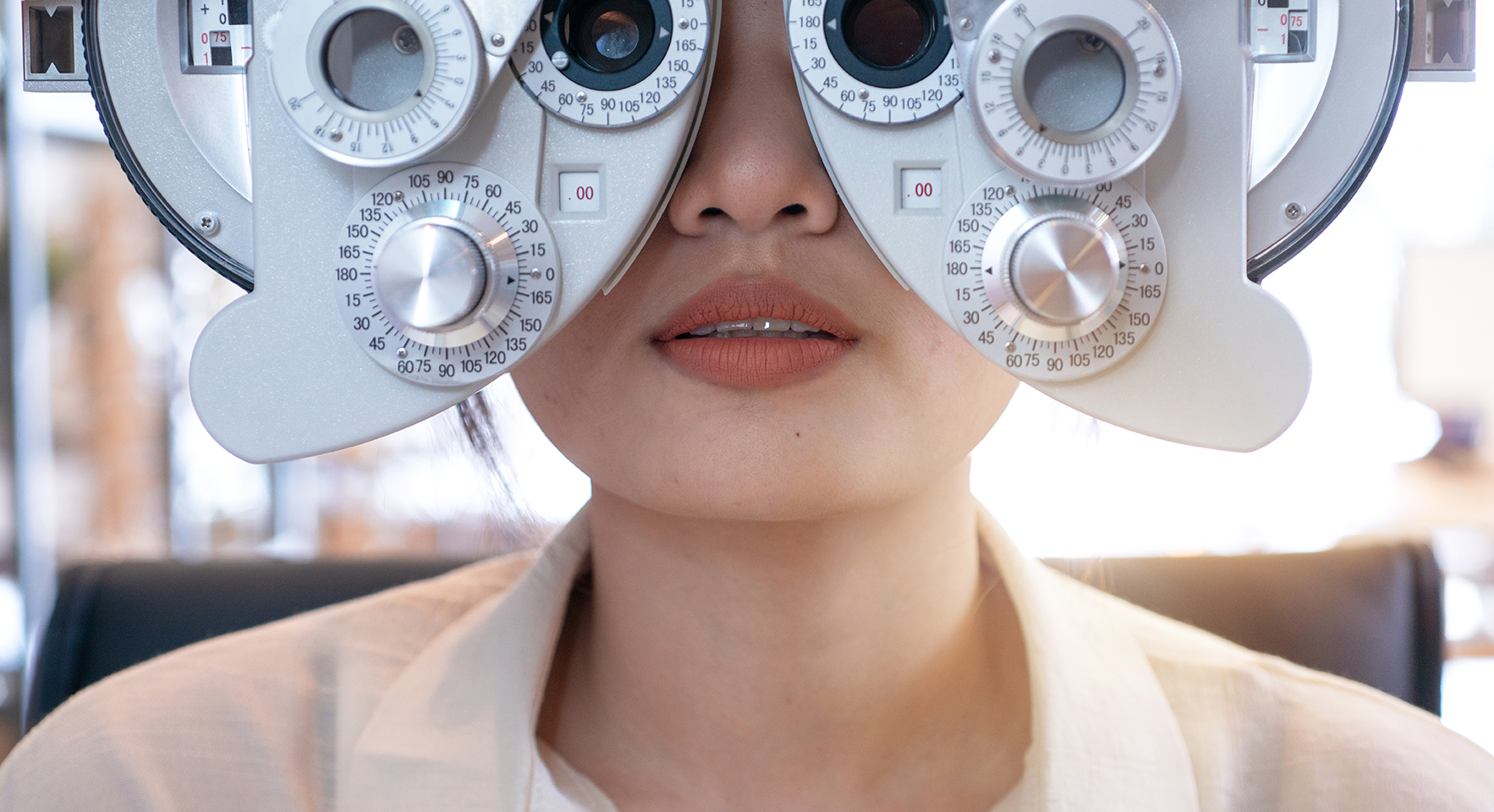 patient looking through instrument for eye exam