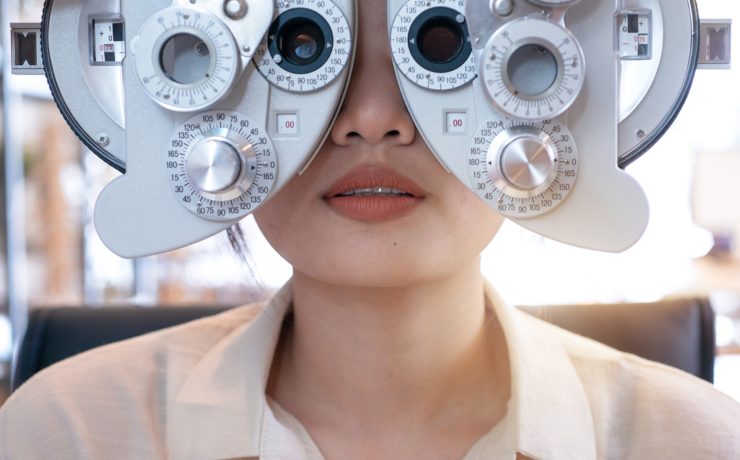 patient looking through instrument for eye exam