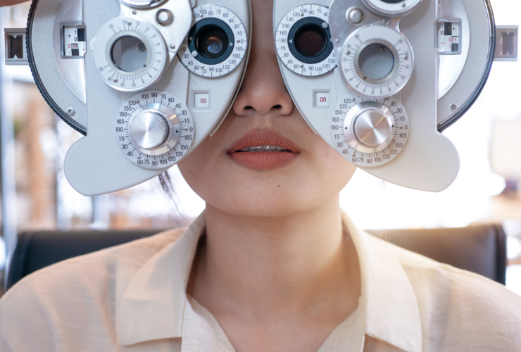 patient looking through instrument for eye exam